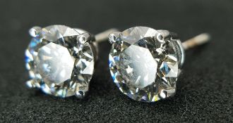A Pair of 18K White Gold and 1.5ctw Lab Diamond Stud Earrings. Having G colour and SI1 clarity.