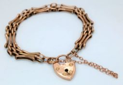 A Childs 9k Yellow Gold Fancy Gate Bracelet with Heart Clasp and Safety Chain. 14cm. 4.25g.