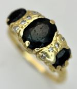 A Vintage 18K Yellow Gold, Sapphire and Diamond Ring. Circa 2.5ctw of oval cut sapphires with