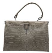 A Bottega Veneta Grey Handbag. Grey crocodile leather and Intrecciato leather exterior with silver-