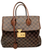 A Louis Vuitton Damier Ebene Ascot Bag. Brown Damier Ebene coated canvas exterior with brown leather
