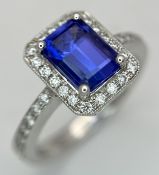 An 18K White Gold, Tourmaline and Diamond Cocktail Ring. An emerald cut 2ct blue tourmaline with a