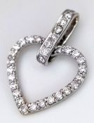 An 18K White Gold and Diamond Heart Shaped Pendant. Brilliant cut set surround with accents on bail.