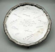 An Antique Sterling Silver Presentation Salver. Features a pie crust rim and four claw-and-ball