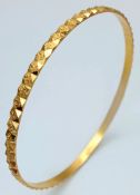 A 22K Yellow Gold Decorative Engraved Bangle. 4mm width. 60mm inner diameter. 10.8g