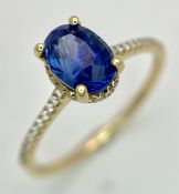 A Sophisticated 18K Yellow Gold, Madagascan Sapphire and Diamond Ring. A high-grade deep blue 1.
