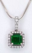 An 18K White Gold, Emerald and Diamond Pendant. A 1ct high-grade square-cut emerald with a 0.15ctw