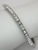 An 18K White Gold and Diamond Tennis Bracelet. Circa 2ctw of round brilliant cut diamonds having G-H
