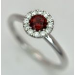 A 9K White Gold, Garnet and Diamond Cluster Ring. 0.10ctw diamonds. Size M. 2.2g total weight.