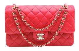 A Chanel Dark Pink Medium Double Flap Bag. Matelasse quilted leather exterior with gold-toned