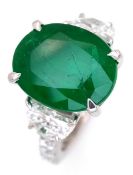 A Stunning 950 Platinum Natural Emerald and Diamond Cocktail Ring. Set with an oval cut 5.69ct