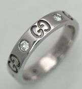 A Gucci Designer 18K White Gold and Diamond Band Ring. Alternating deep set diamonds and double G