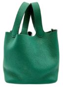 An Hermès Picotin Lock Green Leather Handbag. Green leather exterior with dual top handles, silver-