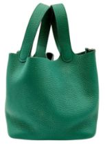 An Hermès Picotin Lock Green Leather Handbag. Green leather exterior with dual top handles, silver-