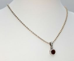 A Beautiful 925 Sterling Silver Garnet Pendant Necklace - 46cm length. The pendant is set with a