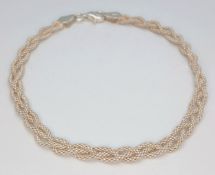 A Lovely 925 Sterling Silver Braided Chain Bracelet - 17cm length. The bracelet has an interwoven