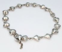 A 925 Sterling Silver Heart Link Bracelet - 18cm length. Formed with a series of linked heart-shaped