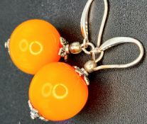 A Pretty Pair of 925 Sterling Silver Amber Drop Earrings. Each earring is set with a round amber
