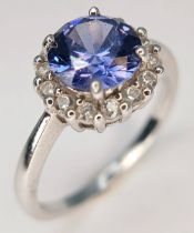 A pretty 925 Sterling Silver CZ Blue Stone Dress Ring. The ring is set with a round faceted blue
