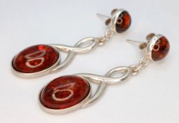 A Pair of 925 Sterling Silver Amber Drop Earrings. 4.5cm drop. 5.8g total weight.