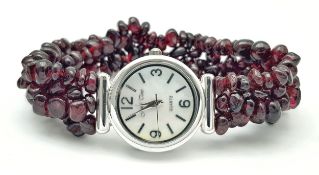 A Ladies Garnet Set Bracelet Quartz Watch by Jewel Time. 24mm Case. Mother of Pearl Face. The