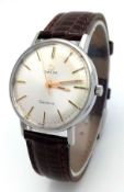 A Vintage Omega Geneve Mechanical Hand-Wind Gents Watch. Brown leather strap. Stainless steel case -