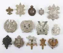 Grouping of British Army Territorial Cap Badges. Included within this lot are the 8th Essex