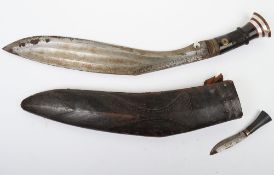 Large Indian Kukri. Blade being 7 cm wide and 45 cm long with decorated hilt overall 60 cm long,