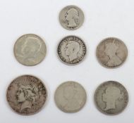 A 1934 Peace dollar, 1881 Victoria Halfcrown, two Victoria Florins,