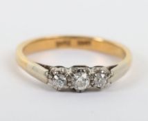 An 18ct and three stone diamond ring,