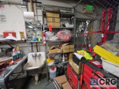 Shelving Rack with Assorted Cleaning Products and First Aid Kits