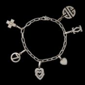 Santos de Cartier charm bracelet in 18ct white gold, with diamond charms, weight: 37,8 g (+)