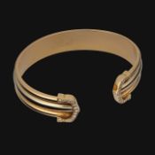 A Cartier Ressort 'Double C' bracelet in 18ct yellow gold and diamonds, weight: 26,9 g (+)