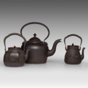 A Japanese 'Phoenix and Dragon Medallion' and a 'Figure in a Riverscape' cast iron tetsubin kettle,