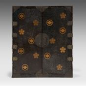A Japanese black and gold lacquered cabinet, Mon symbols on the exterior and the 'Three Friends of W
