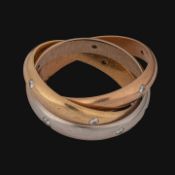 A Cartier Trinity ring in 18ct tricolour gold and diamonds, weight: 12 g (+)