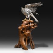 A Japanese silvered bronze okimono of an eagle, perched on a burlwood stand, signed Gyokko, Meiji pe