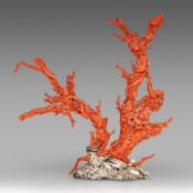A Chinese coral carving, depicting birds on prunus branches, late Qing, fixed on a metal foot, total