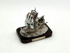 A small silver model of the Golden Hind,