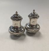 A pair of silver pepperettes,