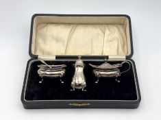 A cased three piece condiment set,