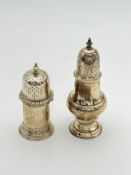 Two silver pepperettes,
