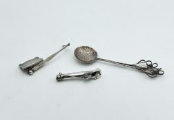 A silver bookmark by Asprey, together with a spoon and corsage holder,