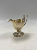 A George III silver helmet shaped cream jug,