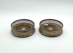 A pair of modern pierced silver coasters,