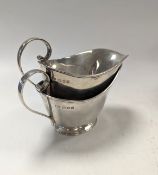 A pair of modern cream jugs,