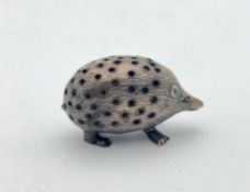 An Edwardian silver hedgehog pin cushion,