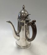A silver chocolate pot,