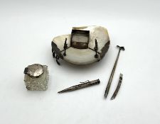 An inkwell, together with a propelling pencil,