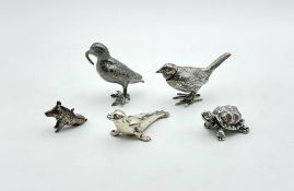 A group of silver animals, together with a plated bird,